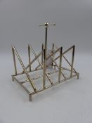 A SILVER PLATED TOAST RACK OF ANGULAR FORM AFTER A DESIGN BY CHRISTOPHER DRESSER.