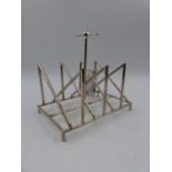 A SILVER PLATED TOAST RACK OF ANGULAR FORM AFTER A DESIGN BY CHRISTOPHER DRESSER.