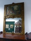 A CARVED AND PAINTED FRENCH LOUIS XV STYLE TRUMEAU MIRROR WITH SHAPED SCENE AFTER BOUCHER ABOVE