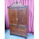 A LATE GEORGIAN COLONIAL HARDWOOD LINEN PRESS WITH SHAPED CORNICE OVER PANELLED DOORS ENCLOSING FOU