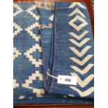 AN INDIAN DHURRIE RUG WITH BLUE GROUND AND GEOMETRIC DESIGN.