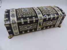 AN ORNATE TORTOISESHELL AND IVORY INDIAN DOME TOP DRESSER BOX WITH PAW FEET. W.26cms.