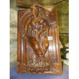 AN EARLY CONTINENTAL CARVED OAK PANEL OF A CLASSICAL LADY HOLDING A CHILD AND A BASKET OF FRUIT.