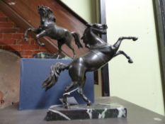 TWO ANTIQUE GRAND TOUR BRONZE FIGURES OF PRANCING HORSES AFTER THE ANTIQUE ON LATER MARBLE BASES.