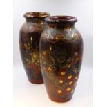 A PAIR OF LARGE JAPANESE POTTERY VASES DECORATED WITH VARIOUS DEITIES AND GROTESQUES. H.39cms.