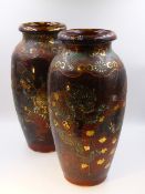 A PAIR OF LARGE JAPANESE POTTERY VASES DECORATED WITH VARIOUS DEITIES AND GROTESQUES. H.39cms.