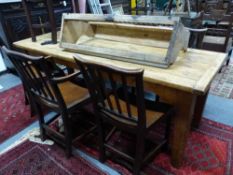 A RUSTIC PINE FARMHOUSE TABLE THE OBLONG TOP WITH BREADBOARD ENDS ON TAPERED LEGS. H.73, L.210, D.