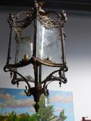 AN IMPRESSIVE FRENCH STYLE HALL LANTERN OF LARGE SIZE WITH SHAPED DECORATED GLAZED PANELS AND SCROLL