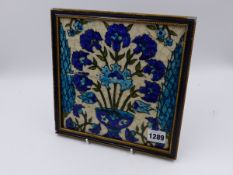 A FRAMED EASTERN GLAZED TILE WITH FLORAL BOUQUET DESIGN. 21x21cms.