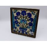 A FRAMED EASTERN GLAZED TILE WITH FLORAL BOUQUET DESIGN. 21x21cms.