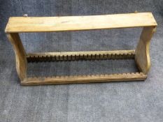 A RUSTIC PINE HANGING PLATE RACK. W.104cms, D.54cms.