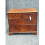 A GEORGIAN AND LATER SMALL FOUR DRAWER CHEST WITH MOULDED EDGE TOP AND CUT OUT BRACKET FEET. H.