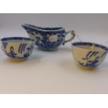 A CHINESE EXPORT BLUE AND WHITE SAUCEBOAT AND TWO TEA BOWLS.