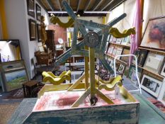 A SCRATCH BUILT TOY WORKING MODEL OF A FERRIS WHEEL WITH PAINTED DECORATION.