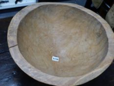 A RUSTIC CARVED DEEP TREEN CONICAL FORM BOWL. H.26, DIA. 43cms.