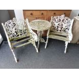A WEATHERED THREE PIECE GARDEN SET OF VICTORIAN STYLE COMPRISING A PAIR OF ARMCHAIRS AND A ROUND
