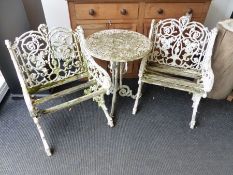 A WEATHERED THREE PIECE GARDEN SET OF VICTORIAN STYLE COMPRISING A PAIR OF ARMCHAIRS AND A ROUND