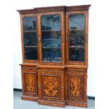 A CONTINENTAL BURL WALNUT MARQUETRY INLAID BREAKFRONT BOOKCASE WITH MOULDED CORNICE ABOVE THREE