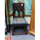 AN ANTIQUE CARVED WALNUT GOTHIC REVIVAL HALL CHAIR WITH PIERCED TRACERY BACK AND FLORAL