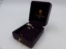 AN ASPREY AND GARRARD THREE STONE DIAMOND RING MOUNTED IN A HALLMARKED PLATINUM SETTING. TOTAL