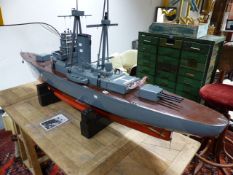 A SCRATCH BUILT MODEL OF A BATTLESHIP CONSTRUCTED AS A WORKING MODEL WITH TWIN ELECTRIC MOTORS.