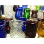 A COLLECTION OF VARIED COLOUR GLASS TEA LIGHTS (33)