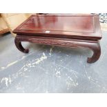 A CHINESE CARVED HARDWOOD LOW TABLE WITH RECTANGULAR TOP AND INCURVED LEGS. 80cms WIDE x 30cms