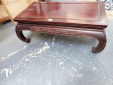 A CHINESE CARVED HARDWOOD LOW TABLE WITH RECTANGULAR TOP AND INCURVED LEGS. 80cms WIDE x 30cms