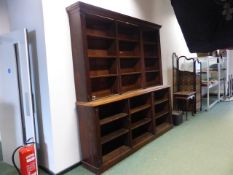 A LARGE LATE 19th C. CARVED OAK TWO PART LIBRARY BOOKCASE WITH MOULDED CORNICE ON PLINTH BASE. W.