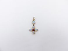 A 15ct GOLD STAMPED OPAL AND RUBY PENDANT. FOUR OVAL BEZEL SET OPALS SURROUND A CENTRAL RUBY AND ARE