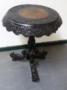 AN ANTIQUE BURMESE CARVED HARDWOOD CENTRE TABLE WITH ELABORATE PIERCED APRON AND WRITHING SERPENT