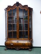 AN ANTIQUE DUTCH CARVED WALNUT DISPLAY CABINET IN THE 18th.C.STYLE. SHAPED CORNICE ABOVE TWO
