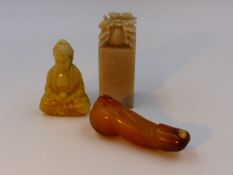 THREE CHINESE CARVED HARDSTONE ARTICLES, A SEATED DEITY, A SEAL AND AN ARCHAIC RITUAL OBJECT.