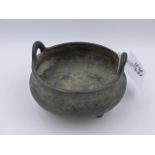 A CHINESE BRONZE TWIN HANDLED TRIFID FOOTED CENSER WITH IMPRESSED SIX CHARACTER MARKS TO BASE. D.