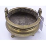 A CHINESE POLISHED BRONZE TWI HANDLED TRIFID FOOTED CENSER WITH SIX CHARACTER MARKS TO BASE AND