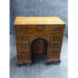 AN ANTIQUE INLAID OAK GEORGIAN KNEEHOLE DROP FRONT BUREAU WITH FITTED INTERIOR, CROSSBANDED WITH