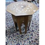 AN ANTIQUE SYRIAN INLAID HARDWOOD OCTAGONAL STAND WITH MOTHER OF PEARL INSETS. H.57, D.45cms.