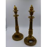 A PAIR OF FRENCH ORMOLU 19th.C. EMPIRE STYLE CANDLESTICKS WITH REEDED SHAFTS SUPPORTED BY TRIFID PAW