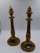 A PAIR OF FRENCH ORMOLU 19th.C. EMPIRE STYLE CANDLESTICKS WITH REEDED SHAFTS SUPPORTED BY TRIFID PAW