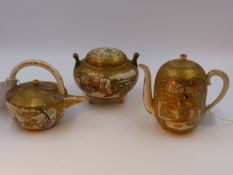 THREE PIECES OF JAPANESE SATSUMA, TWO SMALL TEAPOTS AND A COVERED KORO, ALL EXTENSIVELY DECORATED