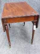 A REGENCY MAHOGANY PEMBROKE TABLE WITH REEDED EGDE TOP, RING TURNED TAPERED LEGS, BRASS CASTORS