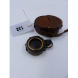 A 1918 MILITARY MARKED MARCHING COMPASS WITH LEATHER CASE.