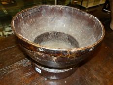 AN EARLY LARGE TURNED WOODEN BOWL WITH STEPPED FOOT AND METAL BOUND RIM. D.37, H.25cms.