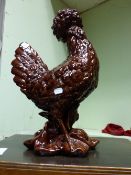 A CONTINENTAL MAJOLICA MODEL OF A COCKEREL AND ANOTHER WITH BROWN GLAZE. 59cms & 48cms (2)