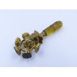 A MID 19th. C. GILT METAL ROTATING WAX SEAL WHEEL WITH AN AMBER COLOURED FACETED CUT GLASS HANDLE.