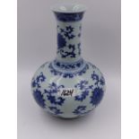 A CHINESE BLUE AND WHITE BOTTLE FORM VASE WITH FLOWER HEAD AND SCROLLING FOLIATE DECORATION. H.27.