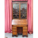 A 19th.C.MAHOGANY KNEEHOLE BUREAU WITH FALL FRONT AND FITTED INTERIOR OVER AN ARRANGEMENT OF SEVEN