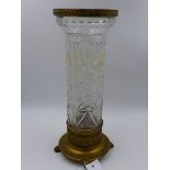 AN ORMOLU MOUNTED FRENCH STYLE CUT CRYSTAL CYLINDER FORM VASE ON CIRCULAR BASE WITH PAW FEET. H.