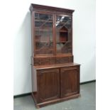 A LATE GEORGIAN MAHOGANY BOOKCASE CABINET WITH ASTRAGAL GLAZED DOORS OVER TWO DEEP DRAWERS AND