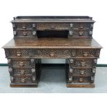 A LARGE LATE 19th.C.CARVED OAK TWIN PEDESTAL DESK WITH RAISED FIVE DRAWER SUPER STRUCTURE OVER. W.